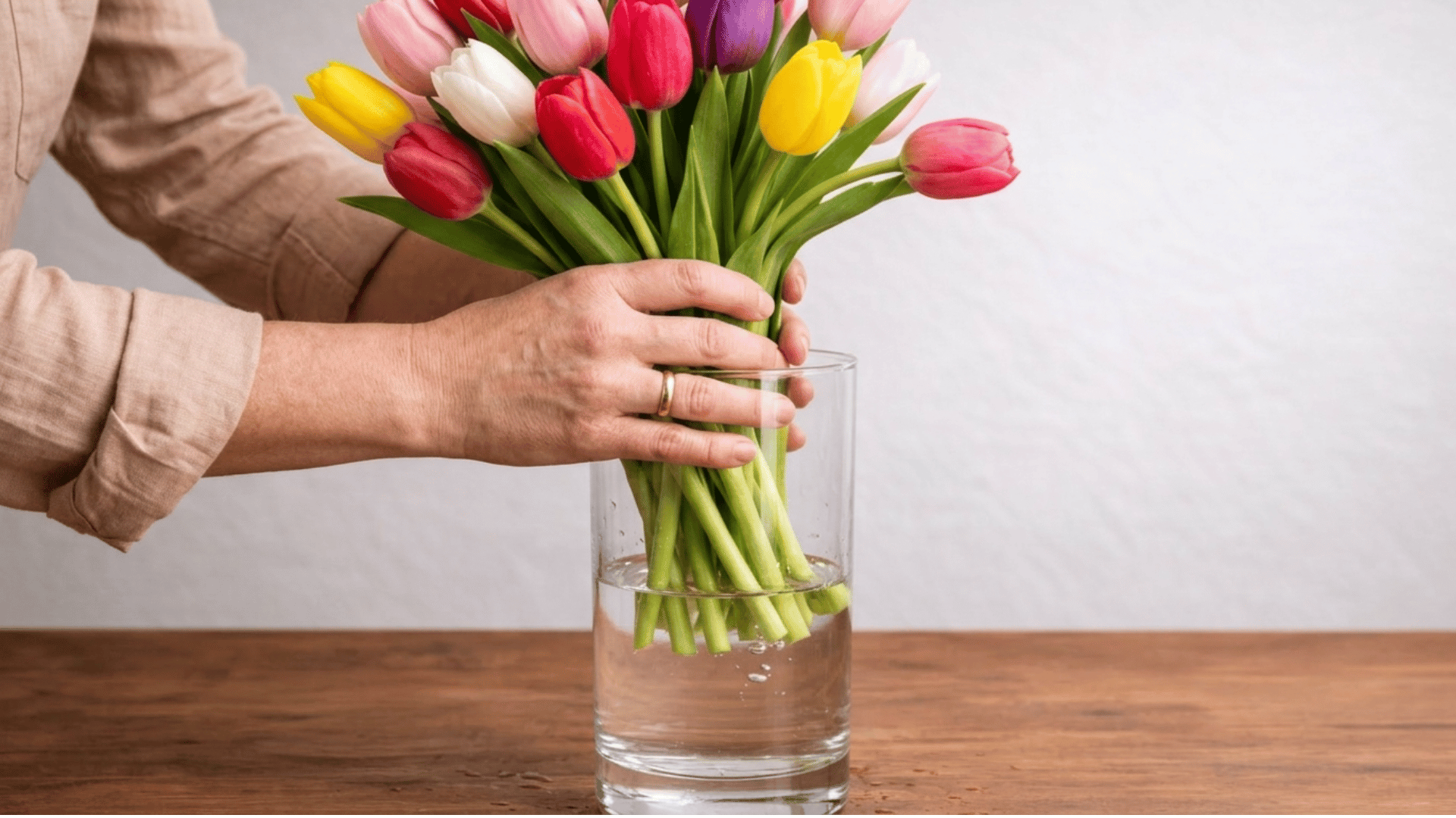 a vibrant tulip bouquet arranged in a clear vase