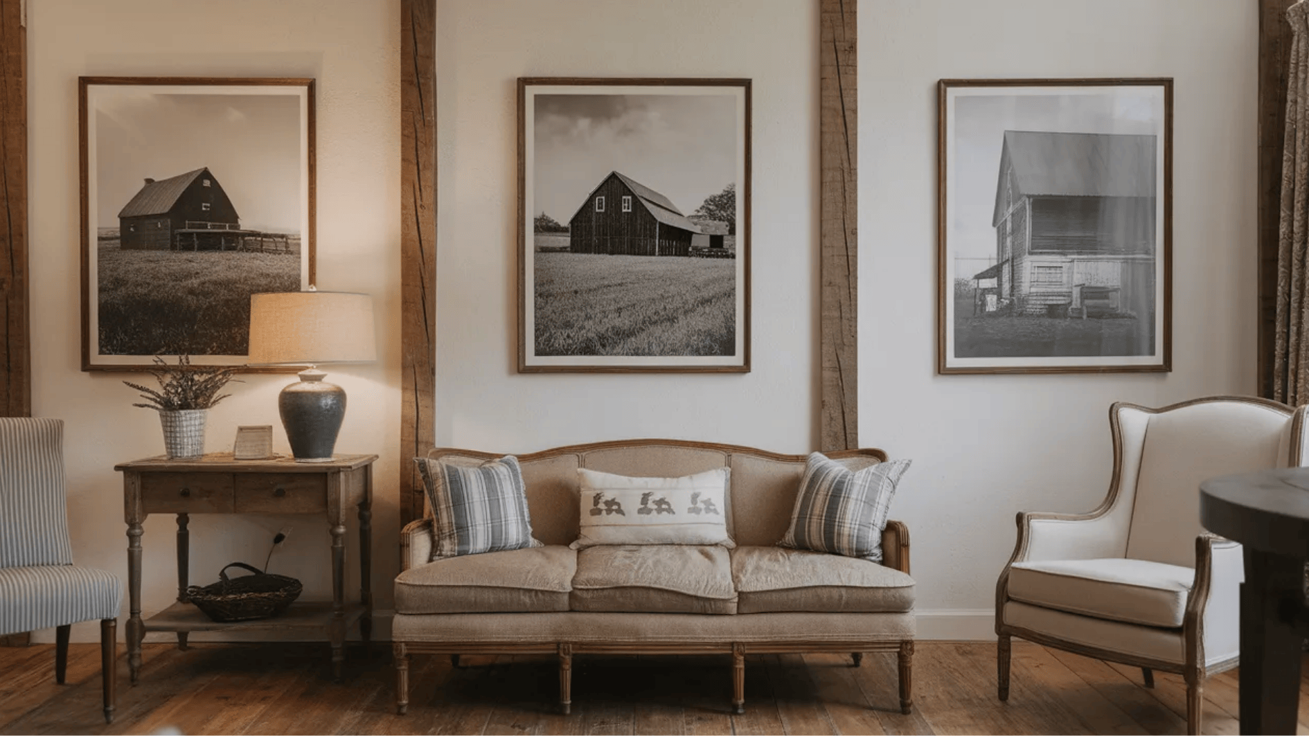cozy living space featuring framed black-and-white barn photographs, rustic furniture, and soft textures for a warm atmosphere