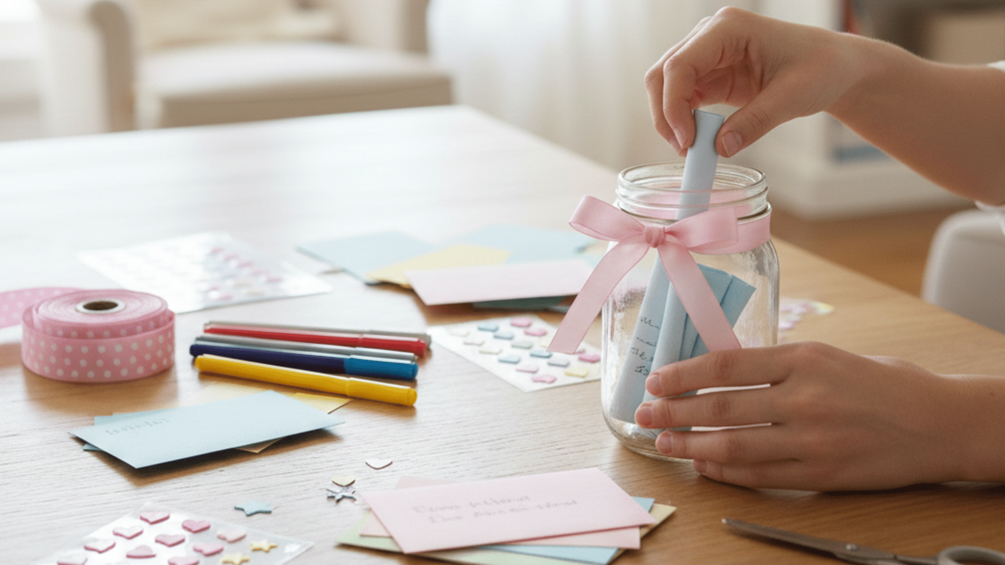 creating a memory jar with colorful paper notes and decorative items on a wooden table