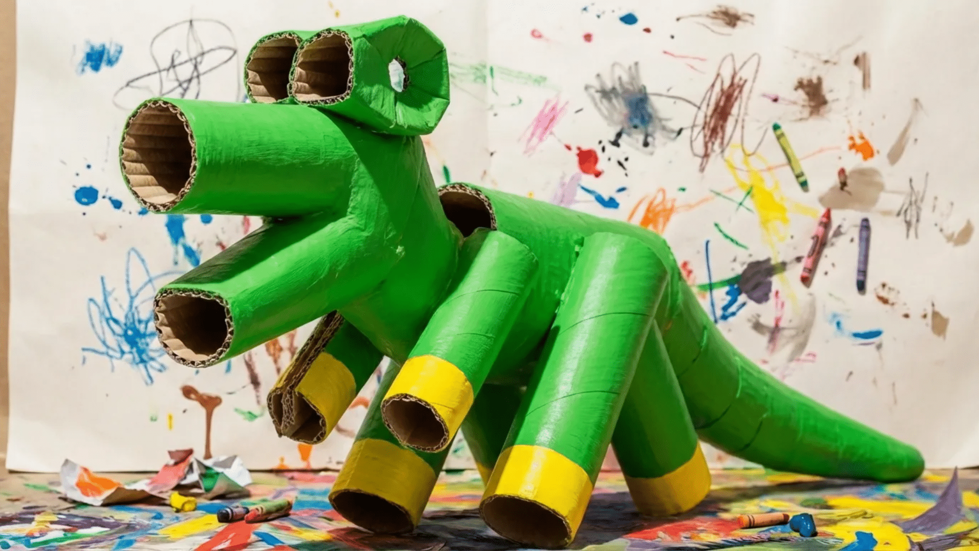 dinosaur cardboard tube sculpture made from slotted cardboard rolls stacked into a creative tower shape
