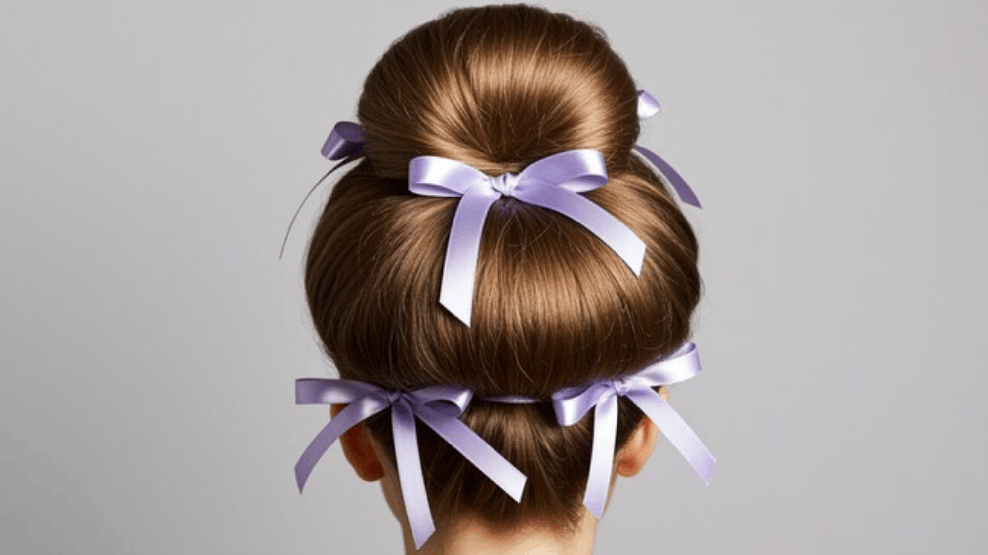 elegant sock bun hairstyle adorned with delicate lavender ribbons, creating a polished and stylish look
