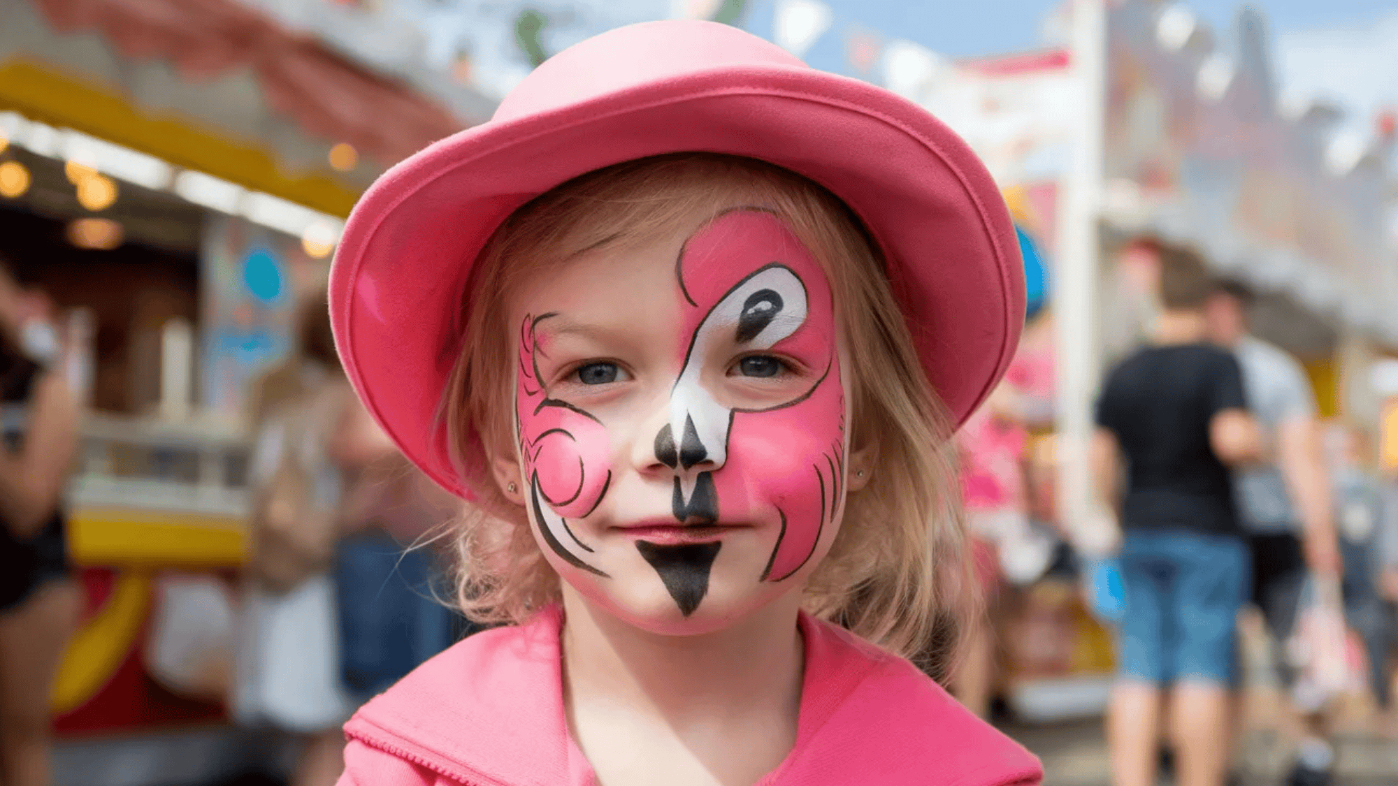 flamingo face paint on a boy with pink, black and white shades