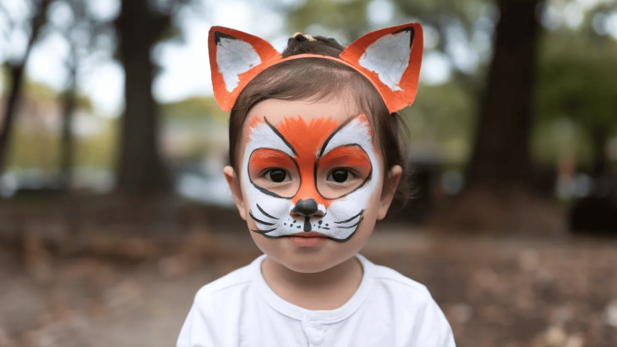 fox face paint on a kid with fox paper ears