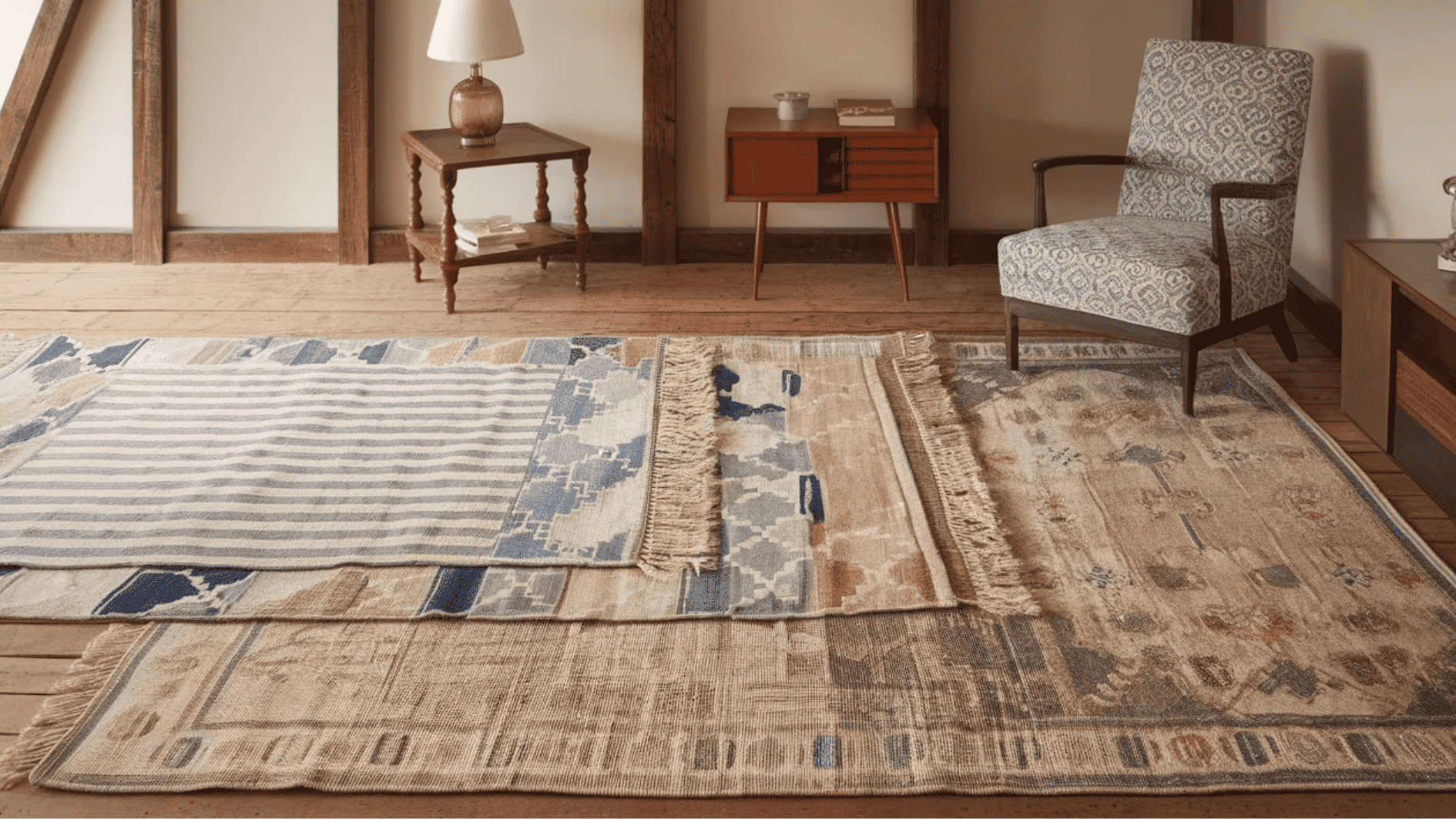 layered rugs with intricate patterns and textures, paired with a cozy armchair and minimalist furniture in a stylish room
