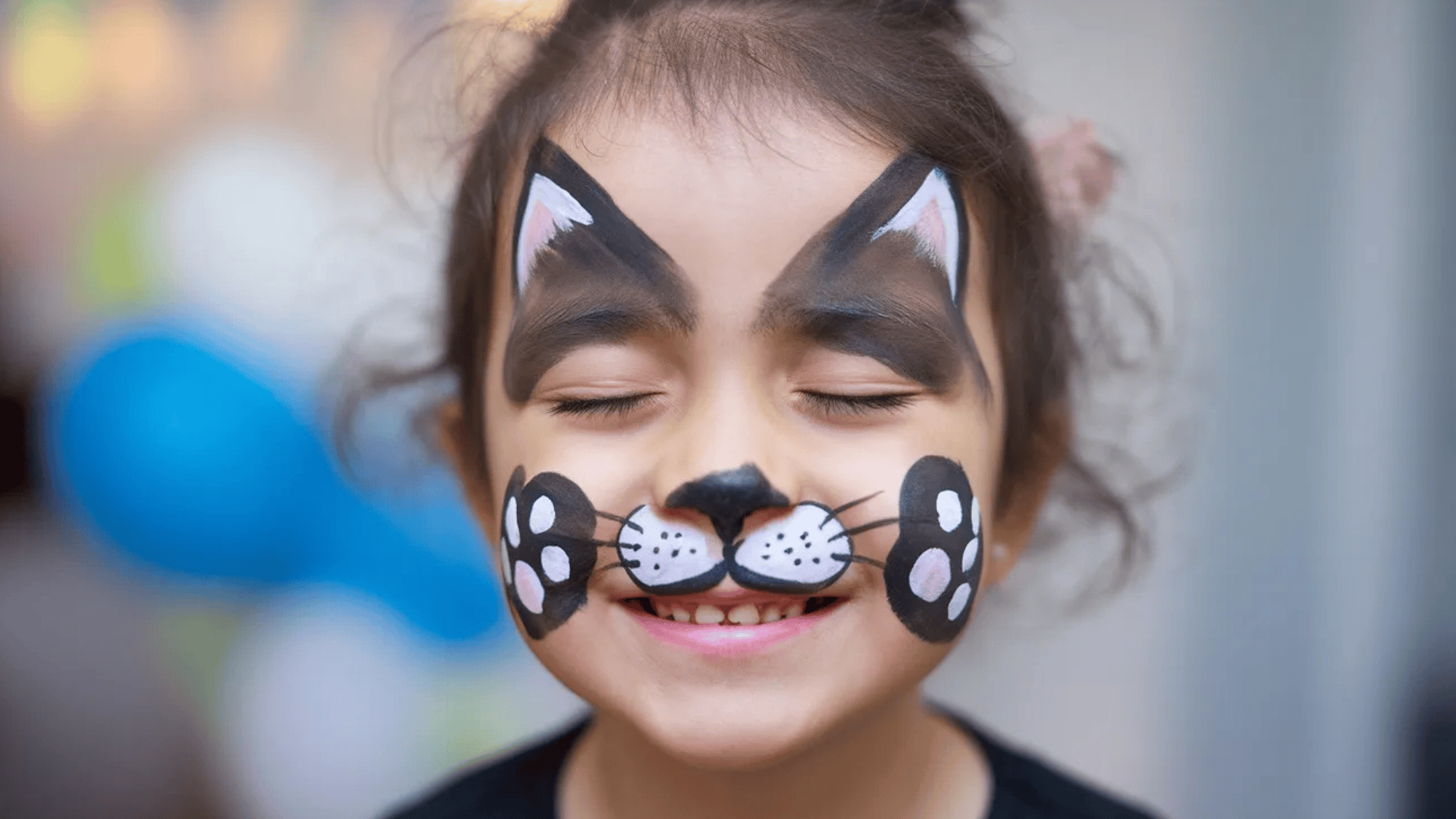 little girl with cat face paint