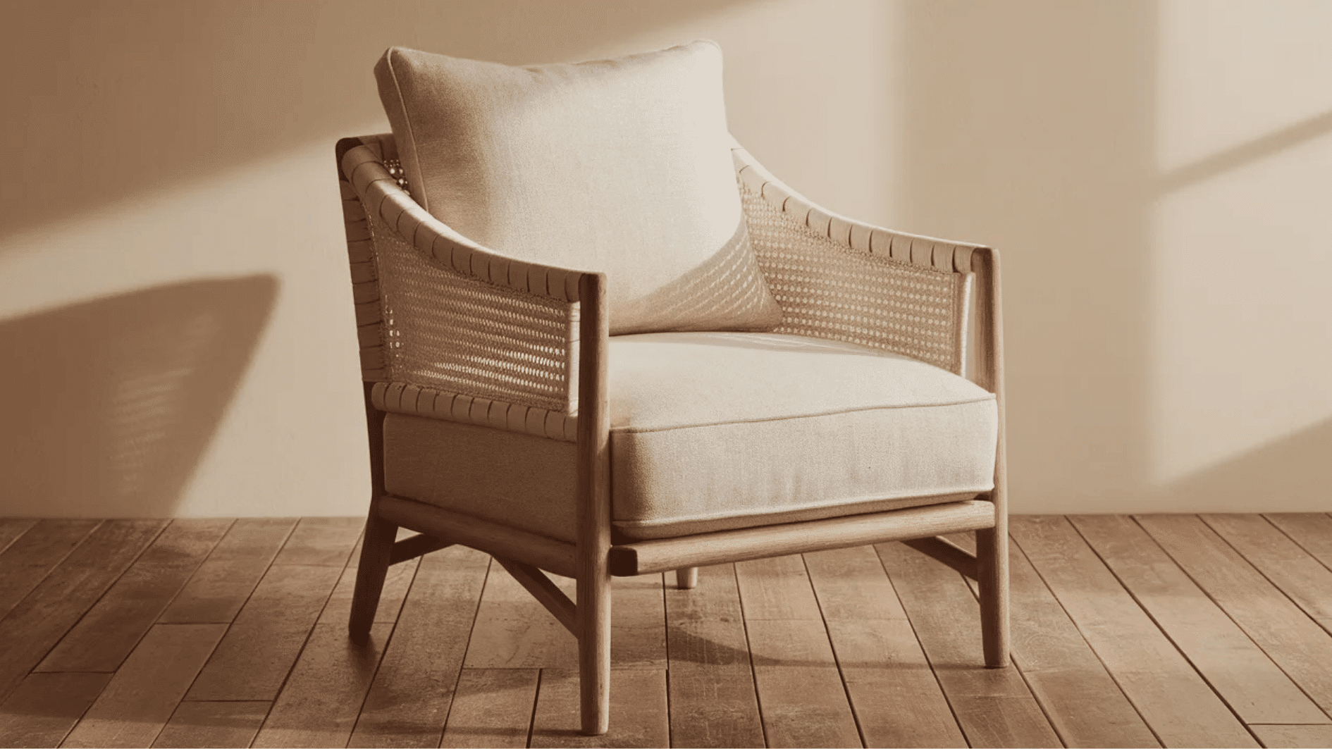 neutral-toned woven armchair with a soft cushion, creating a cozy and minimalist seating option in a warm, earthy room