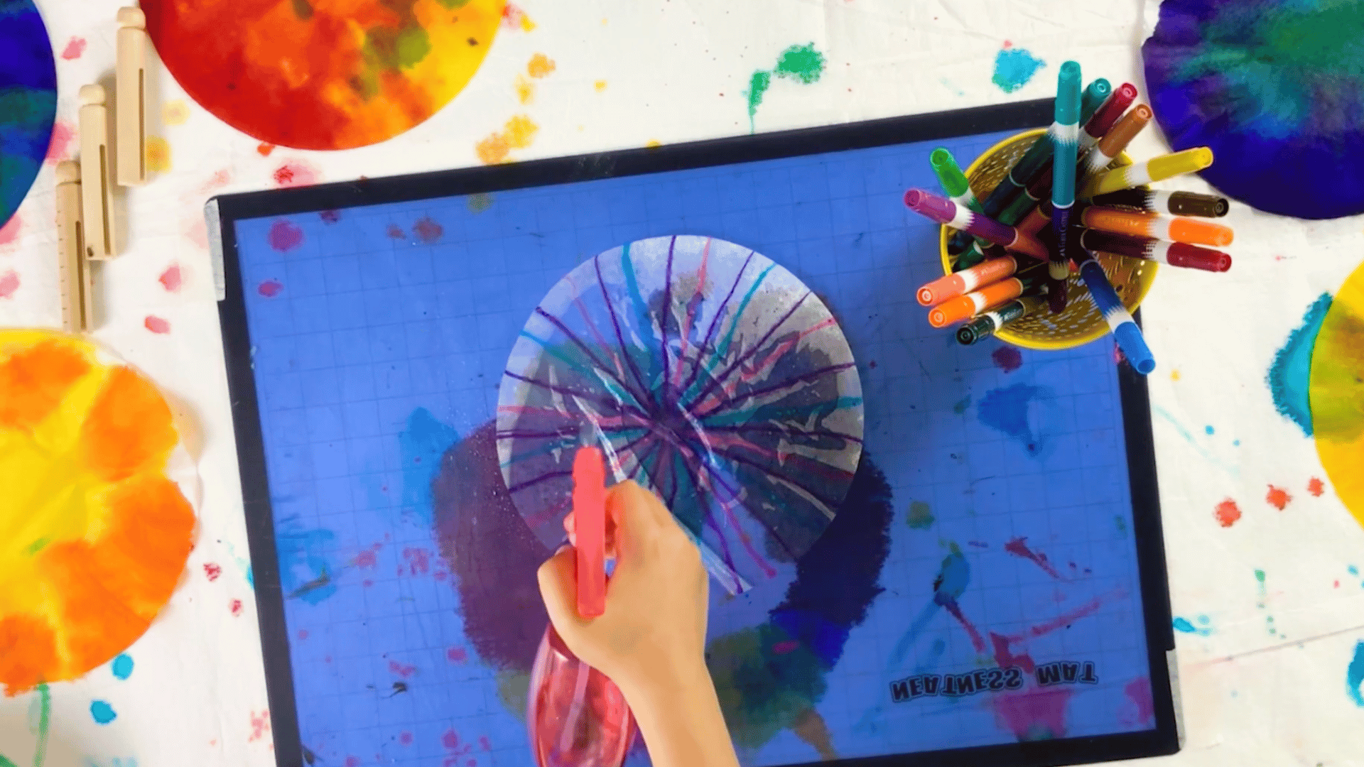 praying water onto a coffee filter to activate marker colors and create a watercolor effect.