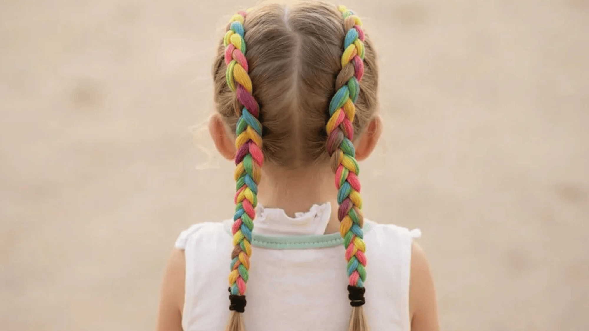 two vibrant braids with multi-colored strands of pink, blue, yellow, and purple, creating a playful and colorful hairstyle