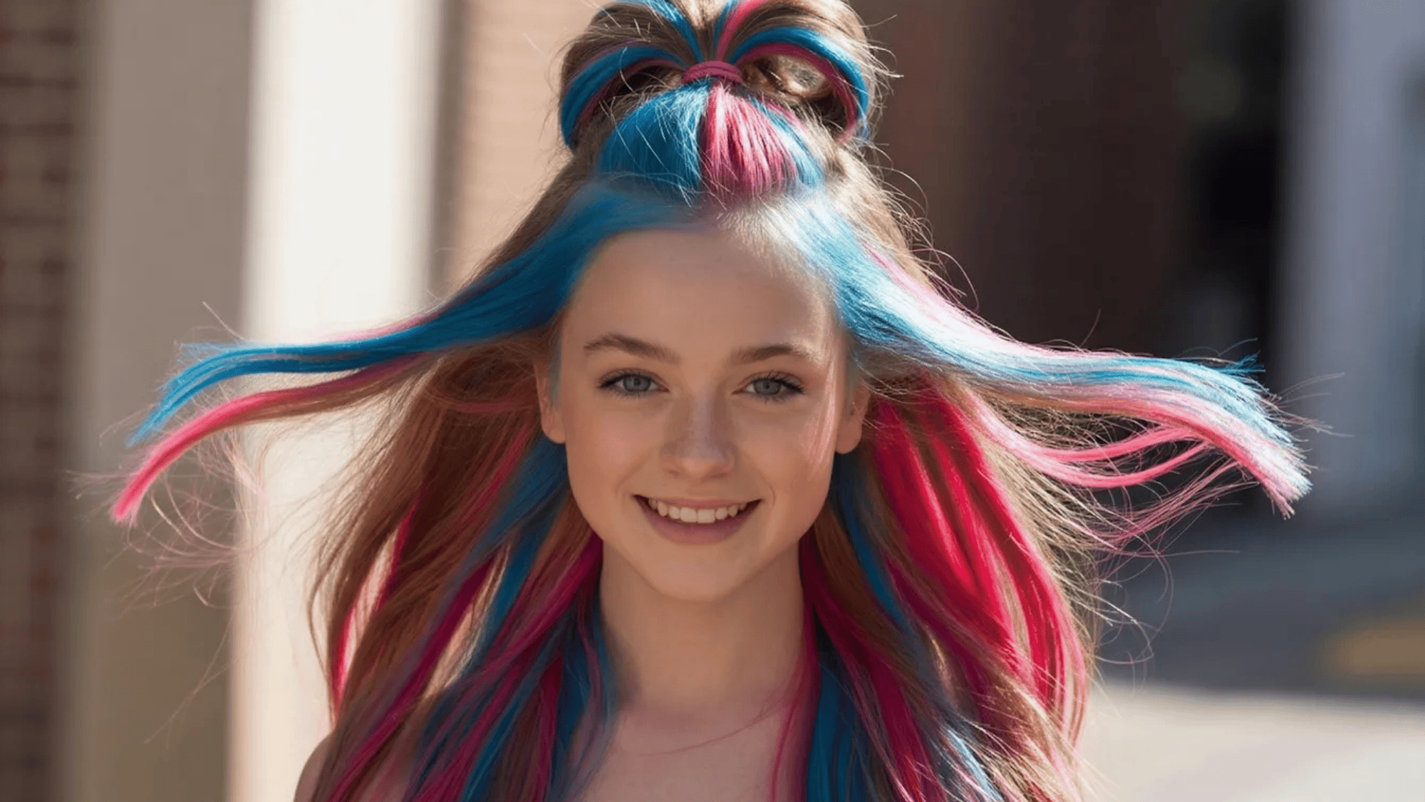 vibrant pink and blue streaked hair, styled in a half-up look with flowing locks, set against a bright outdoor background